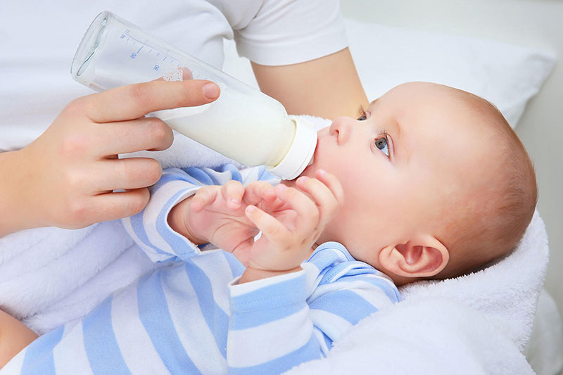 یک کودک در حال استفاده از شیشه شیر